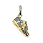 Side view of Links of London gold and black trainer charm