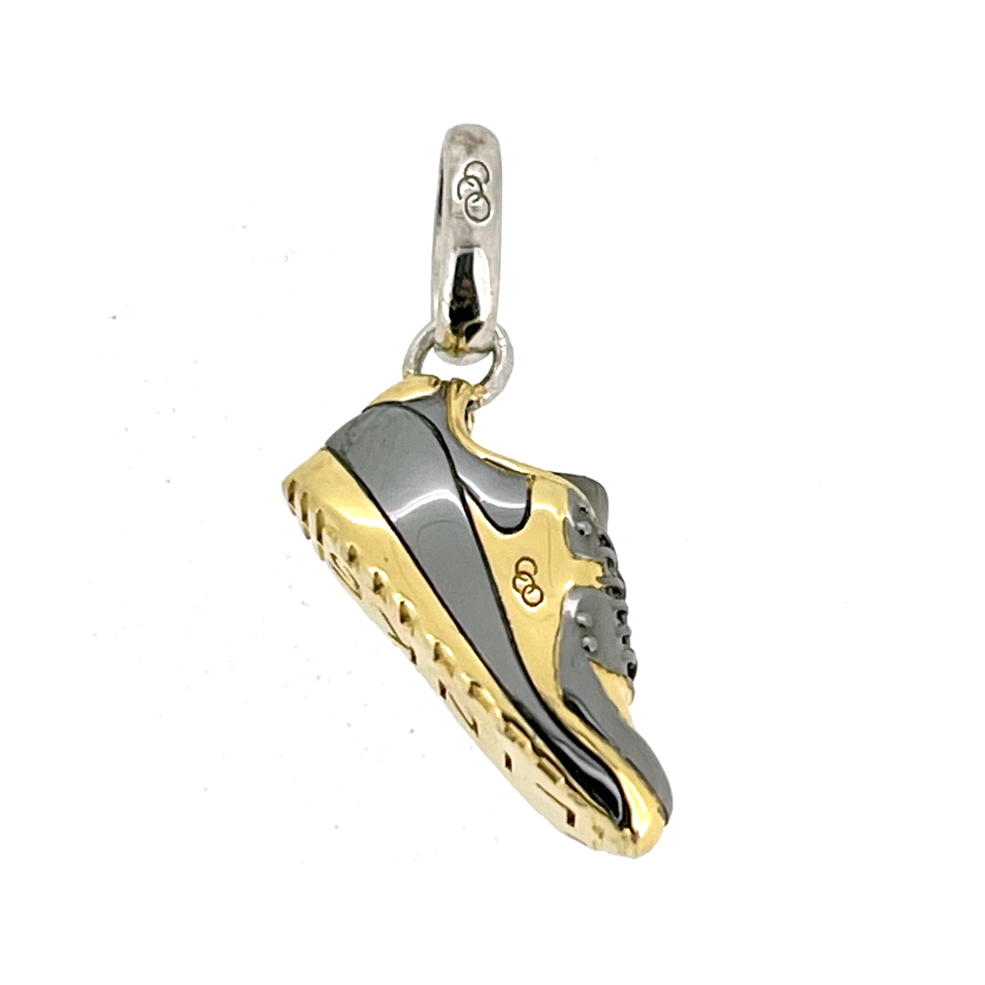Side view of Links of London gold and black trainer charm