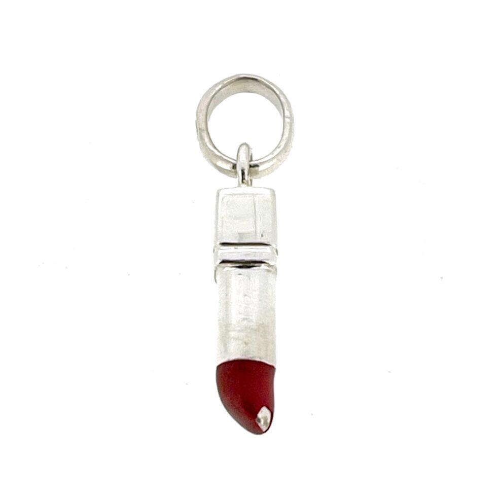 Small vintage silver lipstick charm showing wear