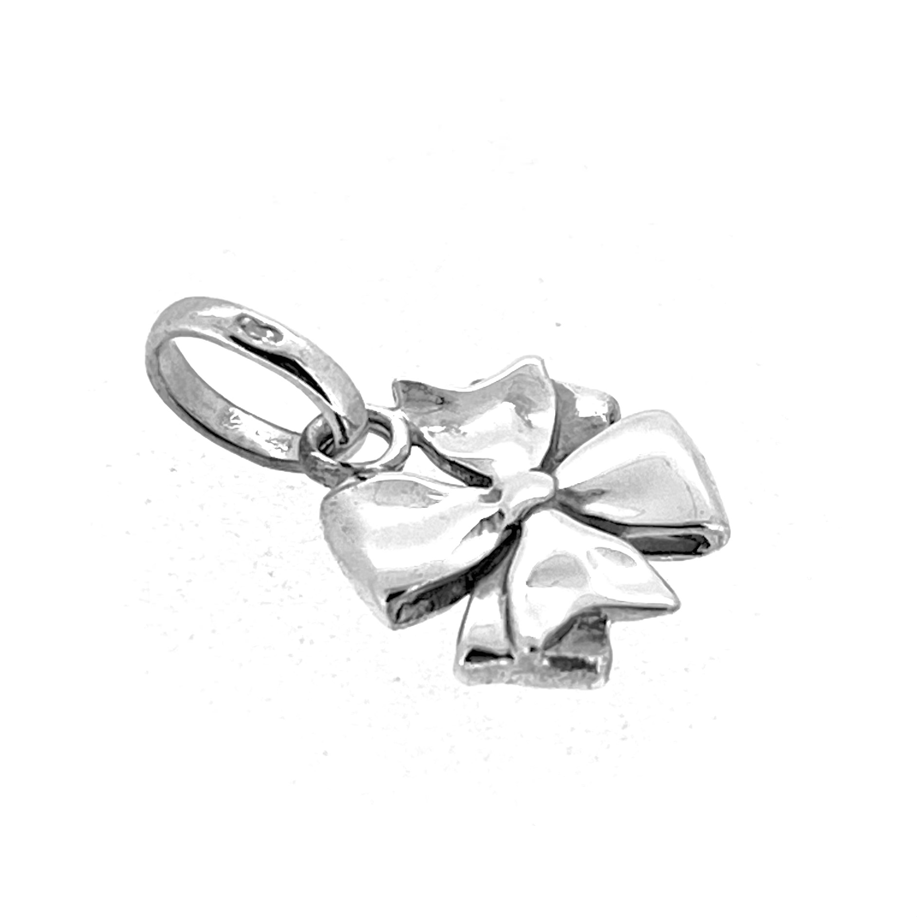 Side view of silver bow charm on white background