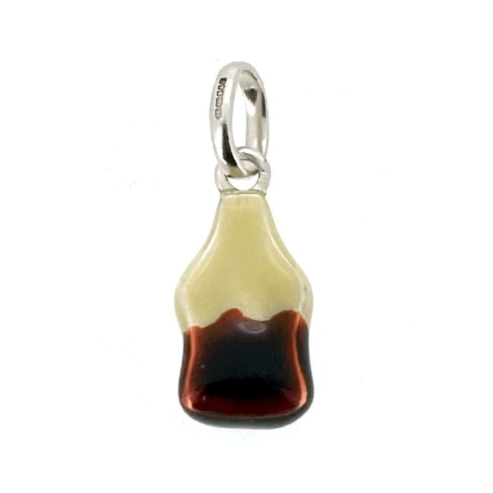 Vintage cola bottle charm photographed on neutral background