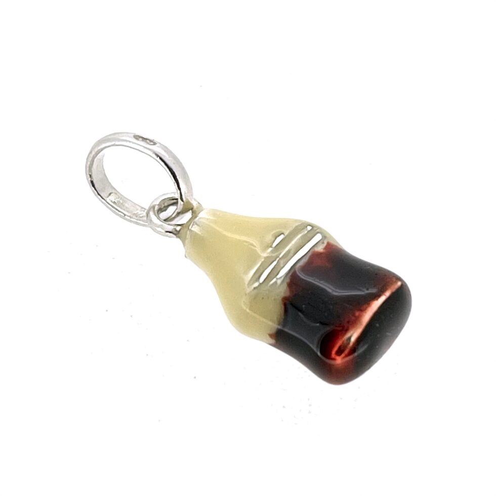 Front view of cola bottle charm showing aged enamel