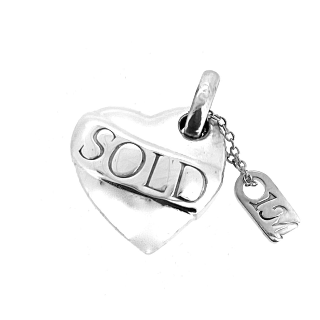 Sterling silver heart charm with 1M tag and three-ring logo