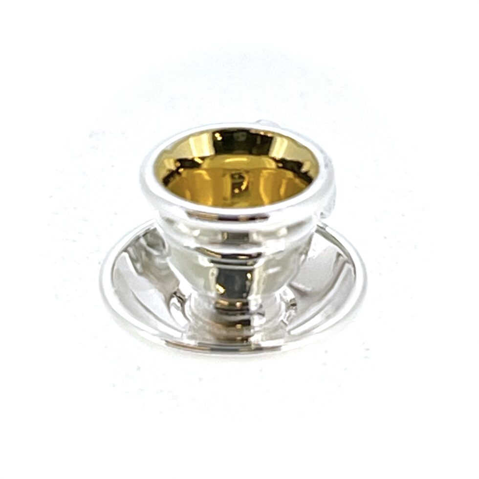 Close-up of teacup charm showing gold-plated interior
