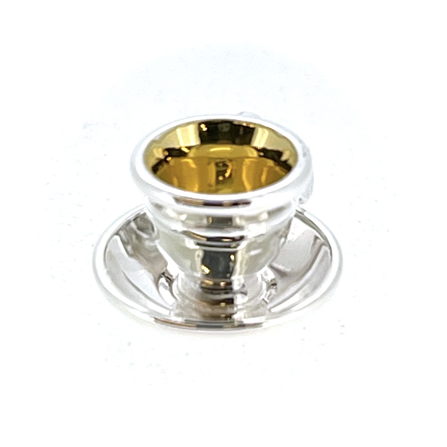 Close-up of teacup charm showing gold-plated interior
