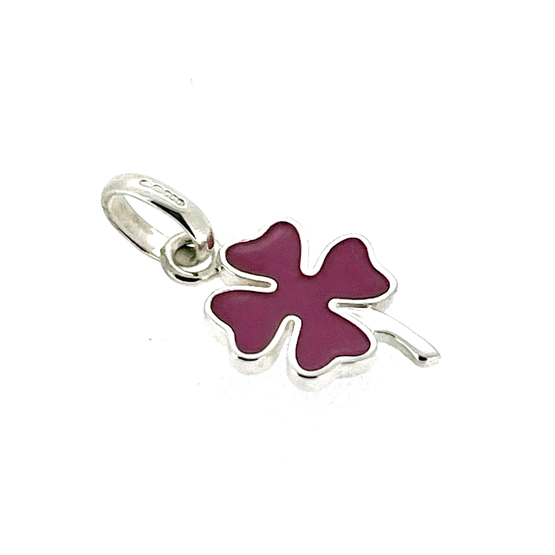 Clover charm on neutral background, angled view