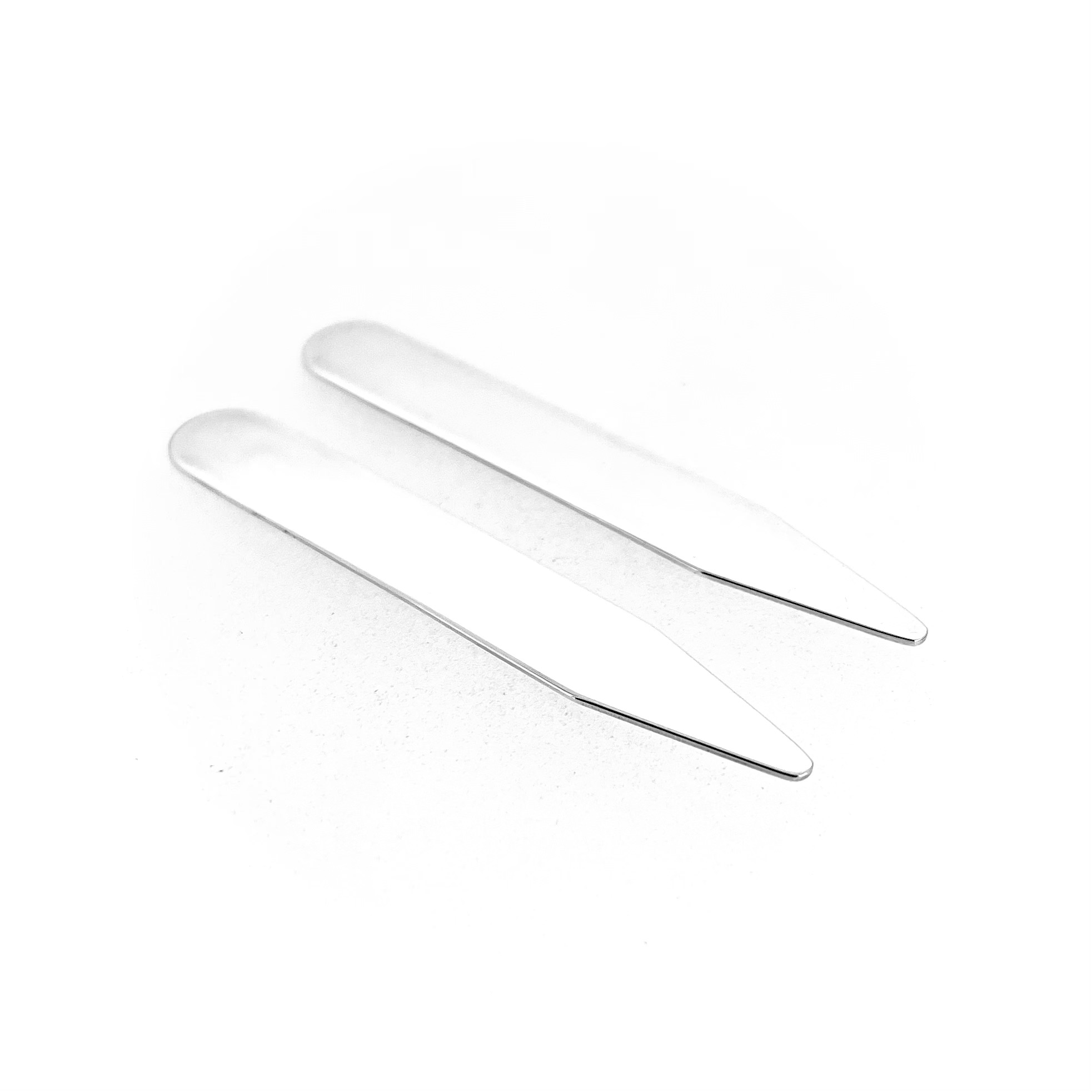 Set of Links of London collar stiffeners on white background