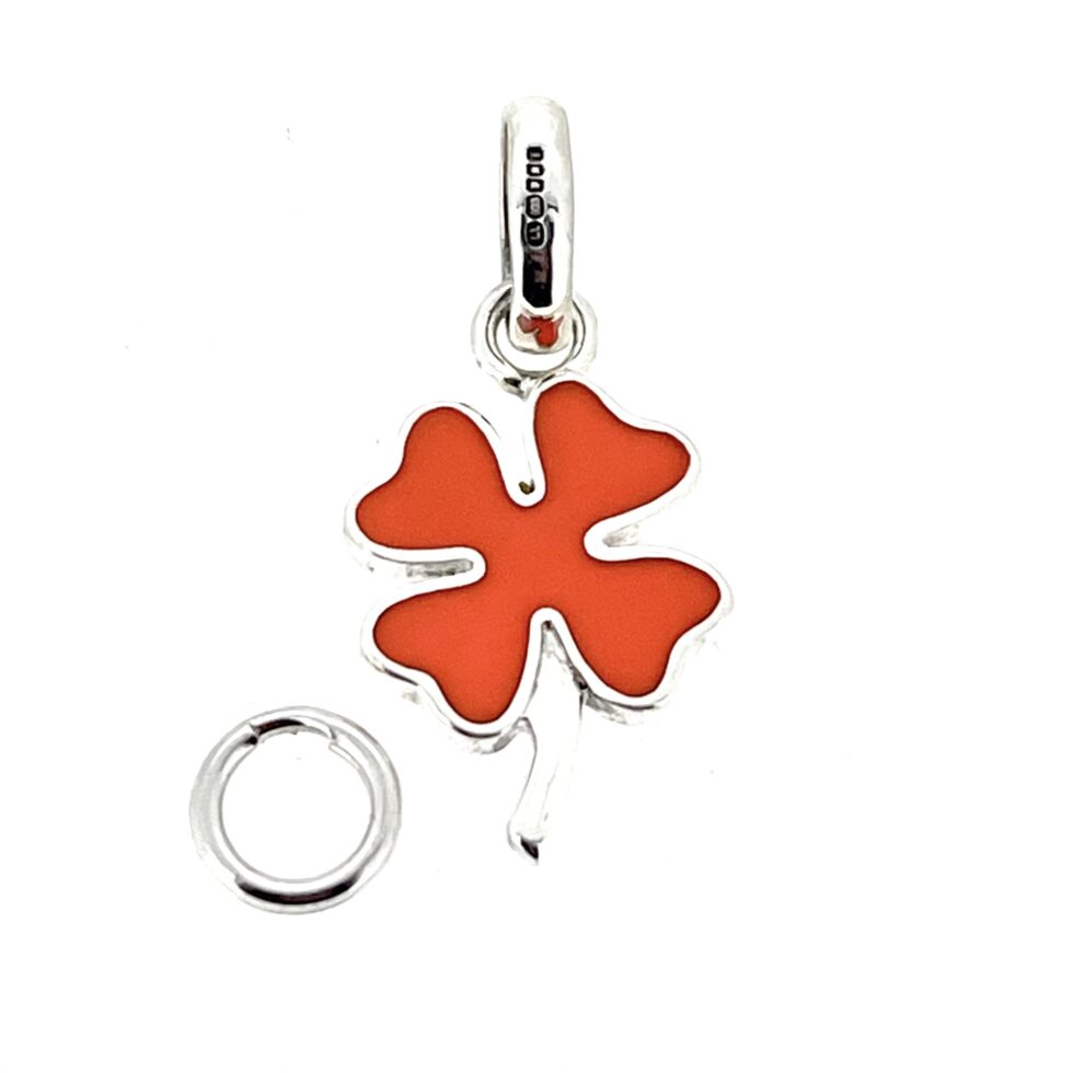 Orange enamel detailing close-up four leaf clover charm