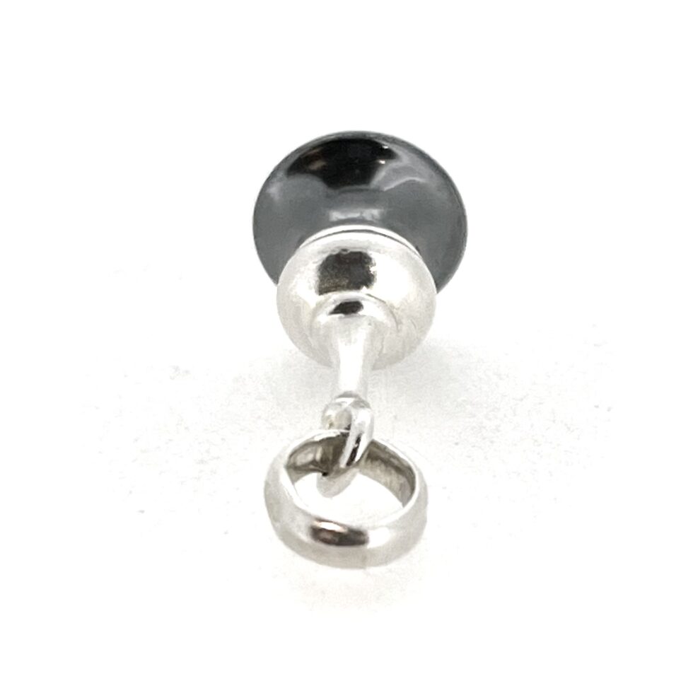 Silver and hematite dome charm photographed flat