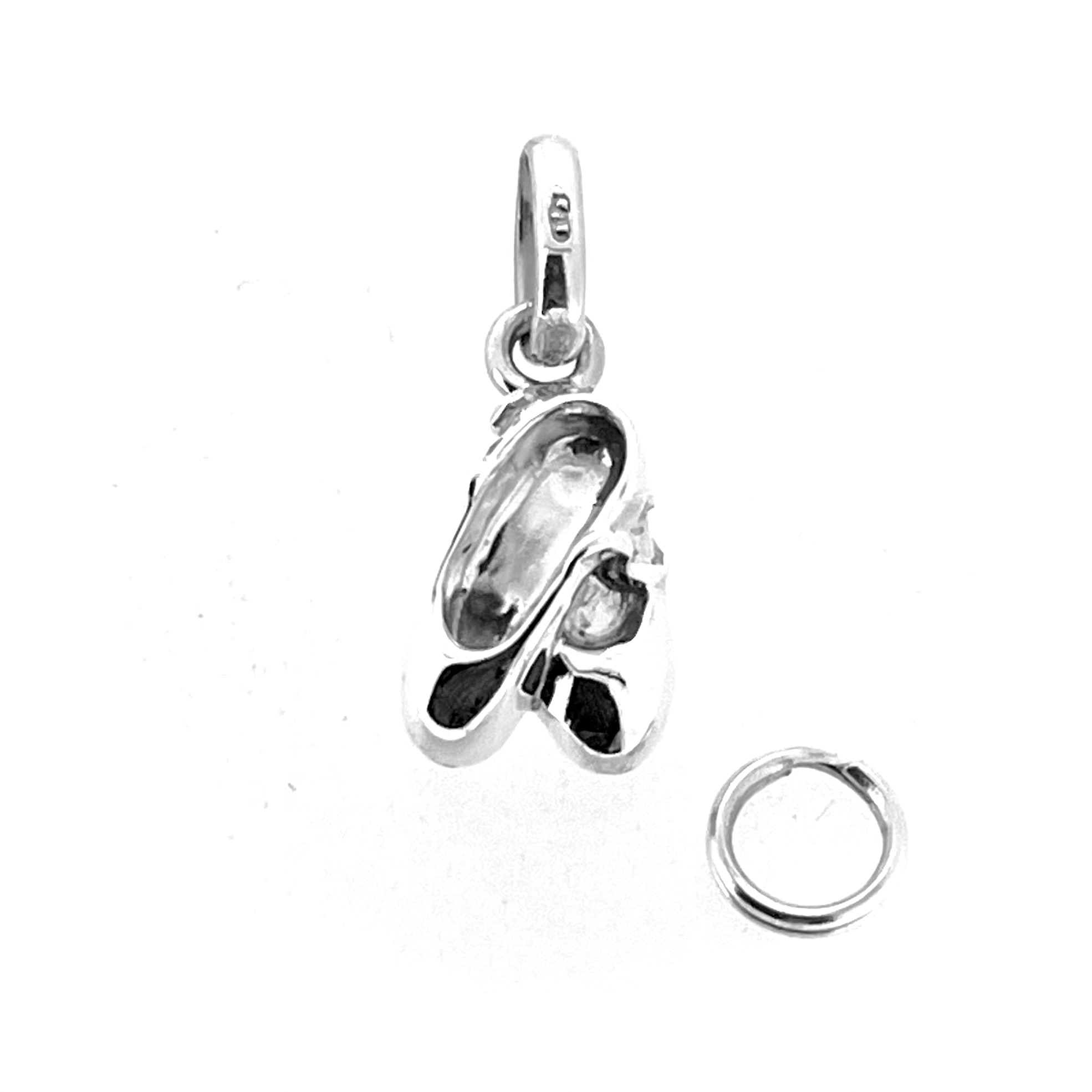 Close-up of silver ballet shoes charm with 2009 hallmark.