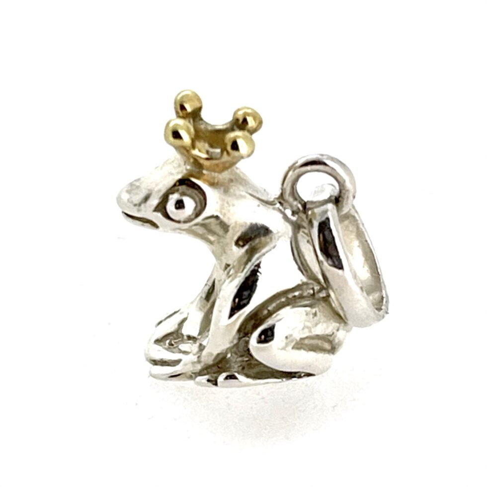 Charm detail showing frog’s eye and crown craftsmanship
