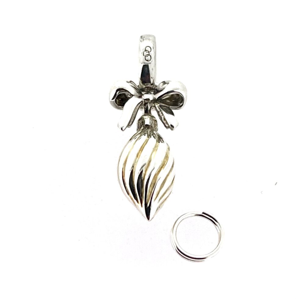 Sterling silver and gold vermeil bauble charm with bow detail.