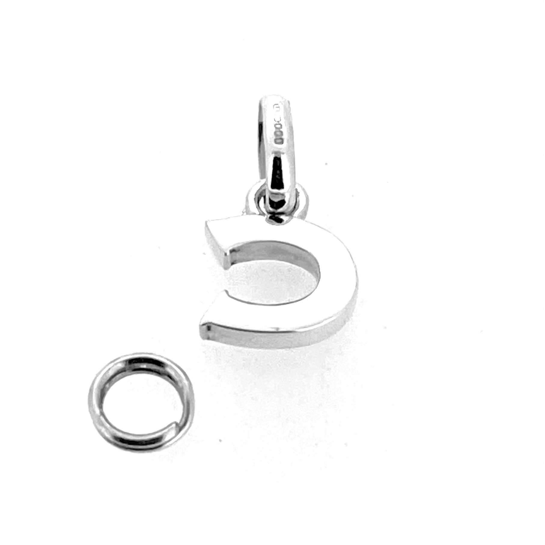 Detail of hallmarks on modern block letter C charm