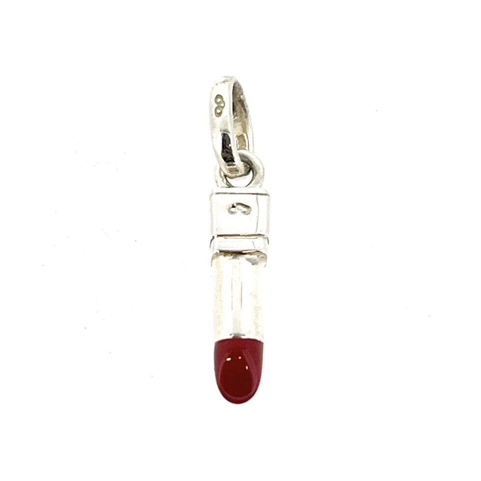 Red enamel lipstick charm photographed on white background