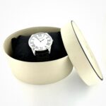 Watch displayed with original cream oval box