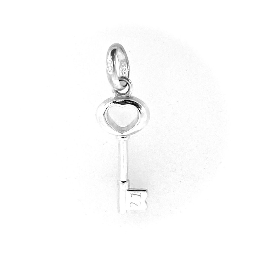 Close-up of 21 engraved on bit of charm key