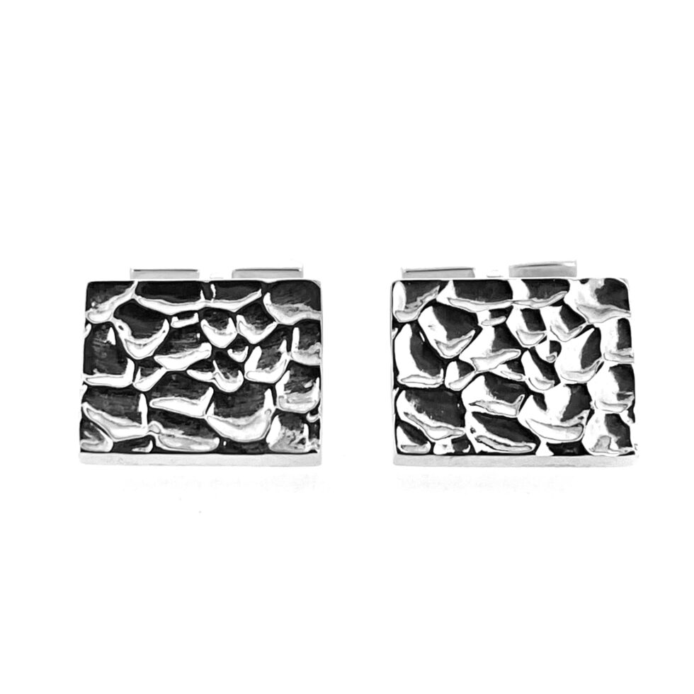 Polished reticulated silver cufflink faces close-up