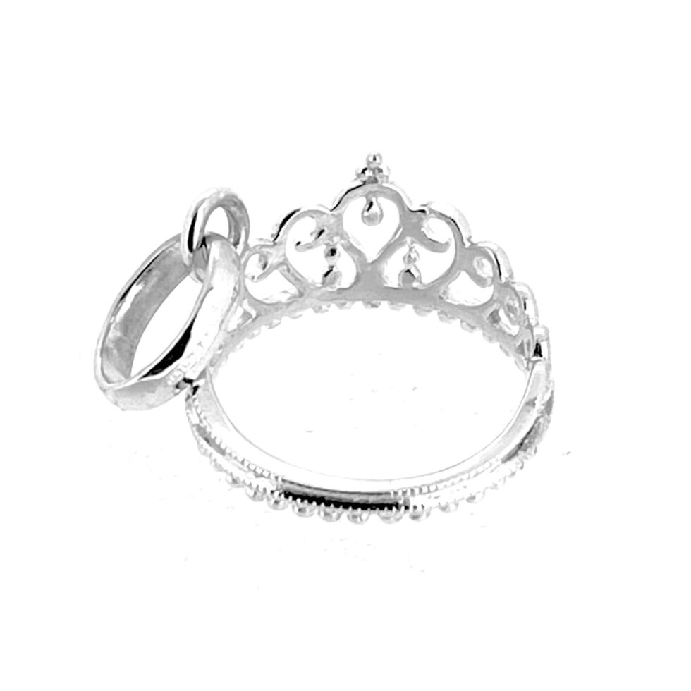 Polished surface of tiara charm catching light.