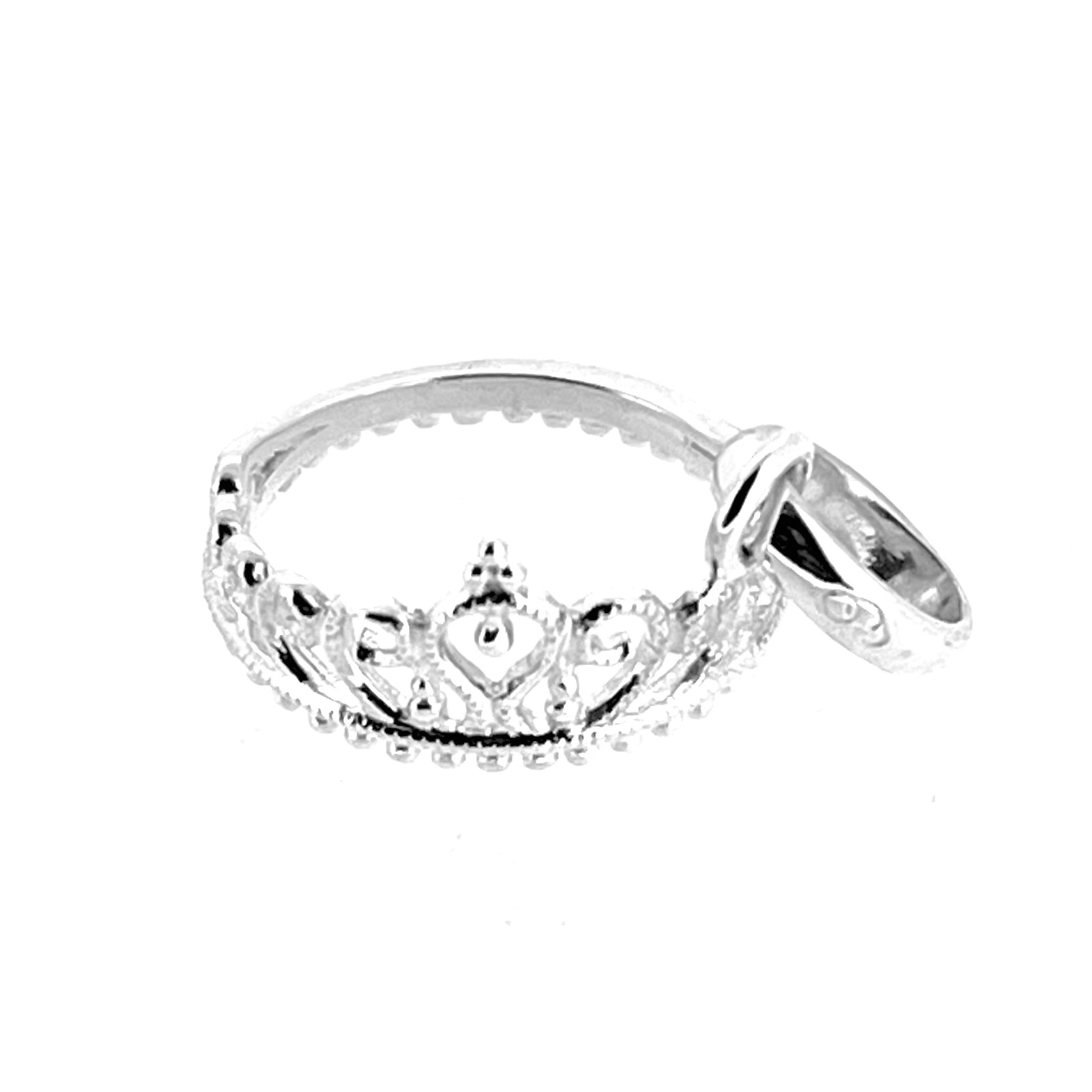 Macro of tiara detail showing curved arches and polished finish.