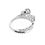 Polished silver Links of London tiara charm on white background.