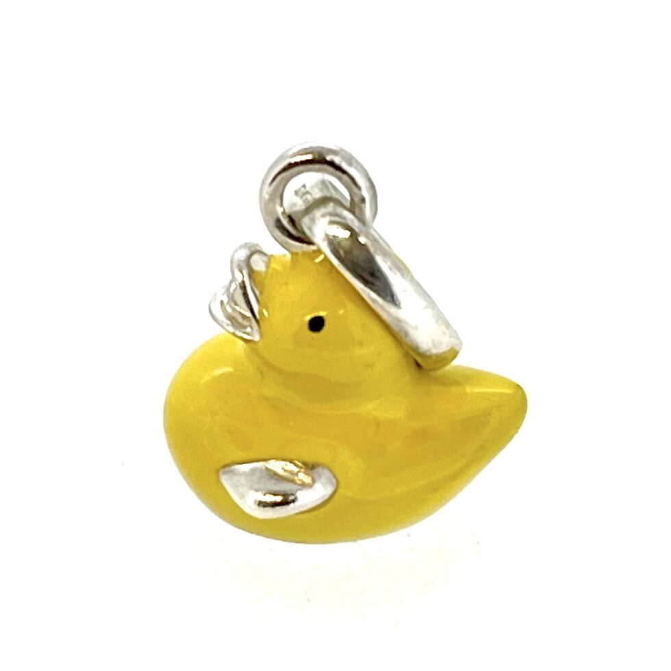 Yellow enamel charm photographed on white background