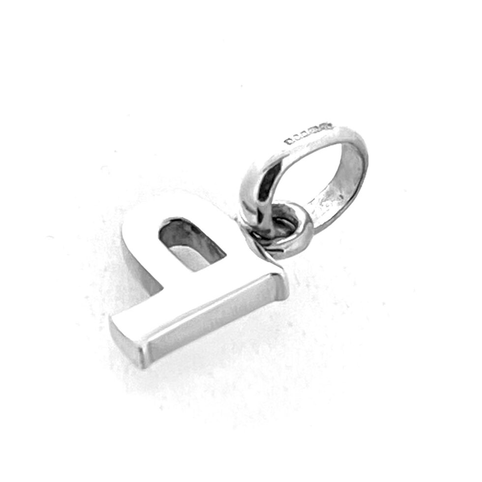 Polished silver block letter P photographed under light