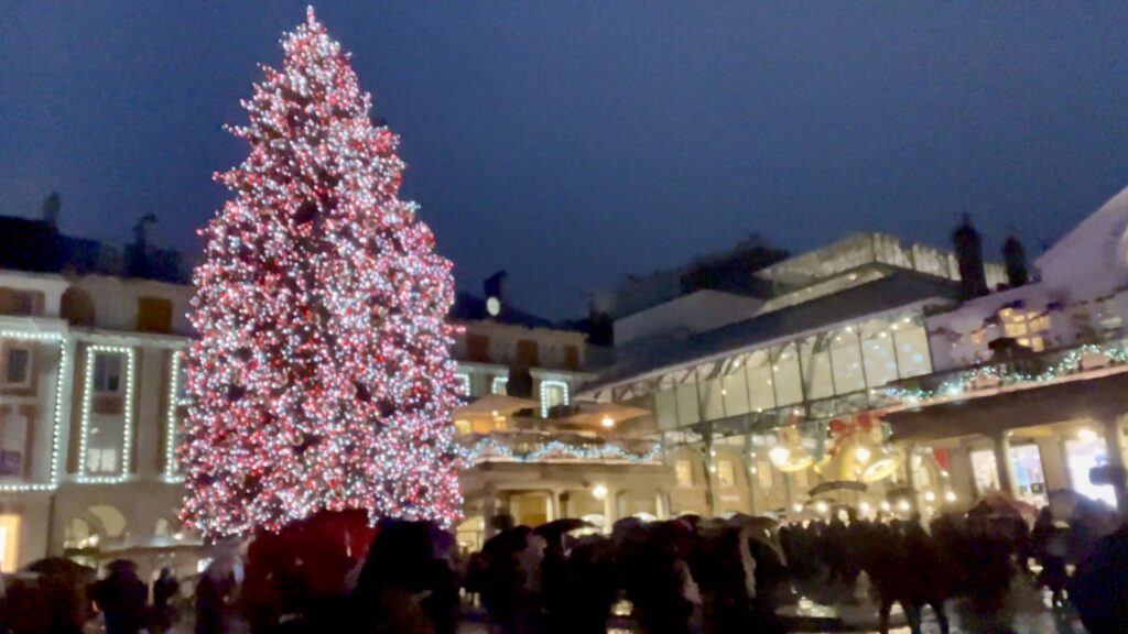 Rainy evening view of Covent Garden Christmas lights in London