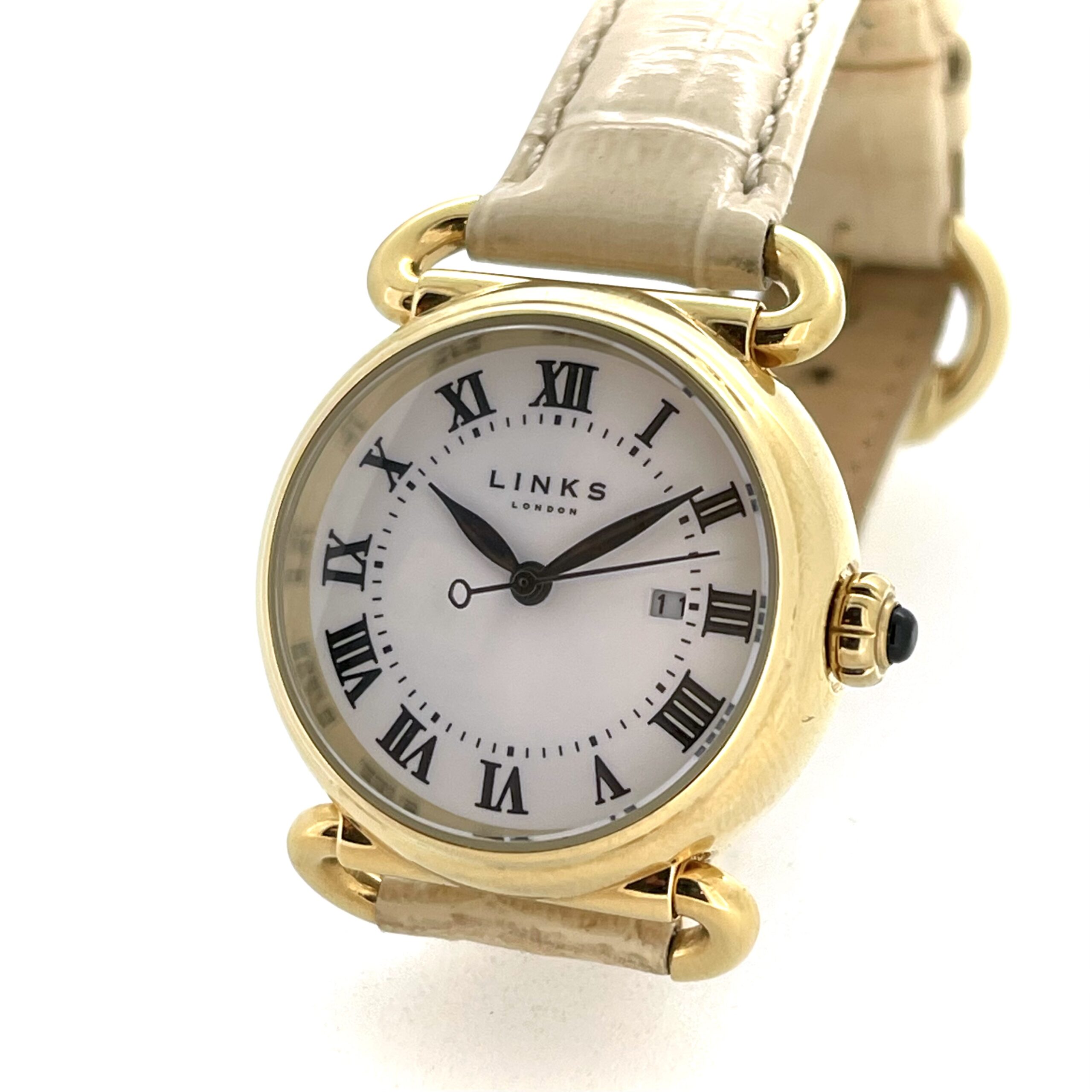 Close-up of white enamel dial with black Roman numerals and leaf-shaped hands.