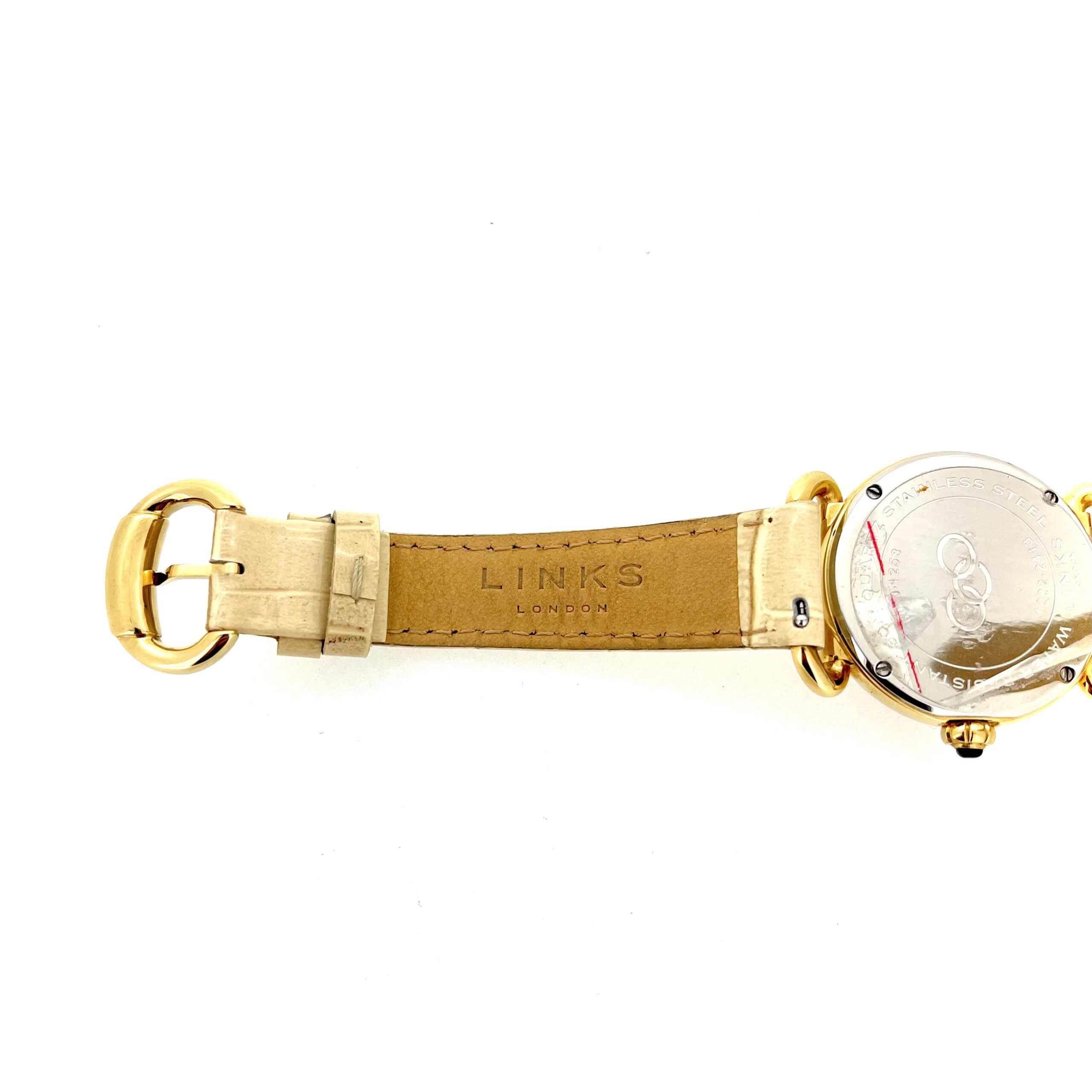 Cream crocodile-pattern leather strap attached to bow-style lugs.