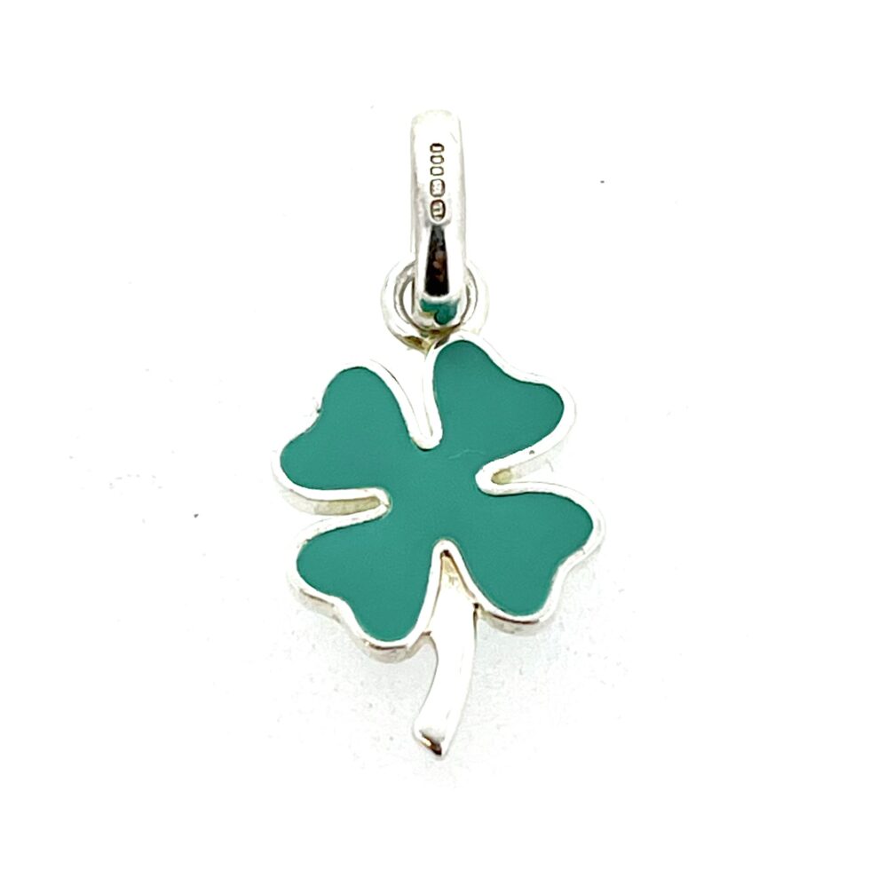 Opaque green enamel clover charm photographed on white background