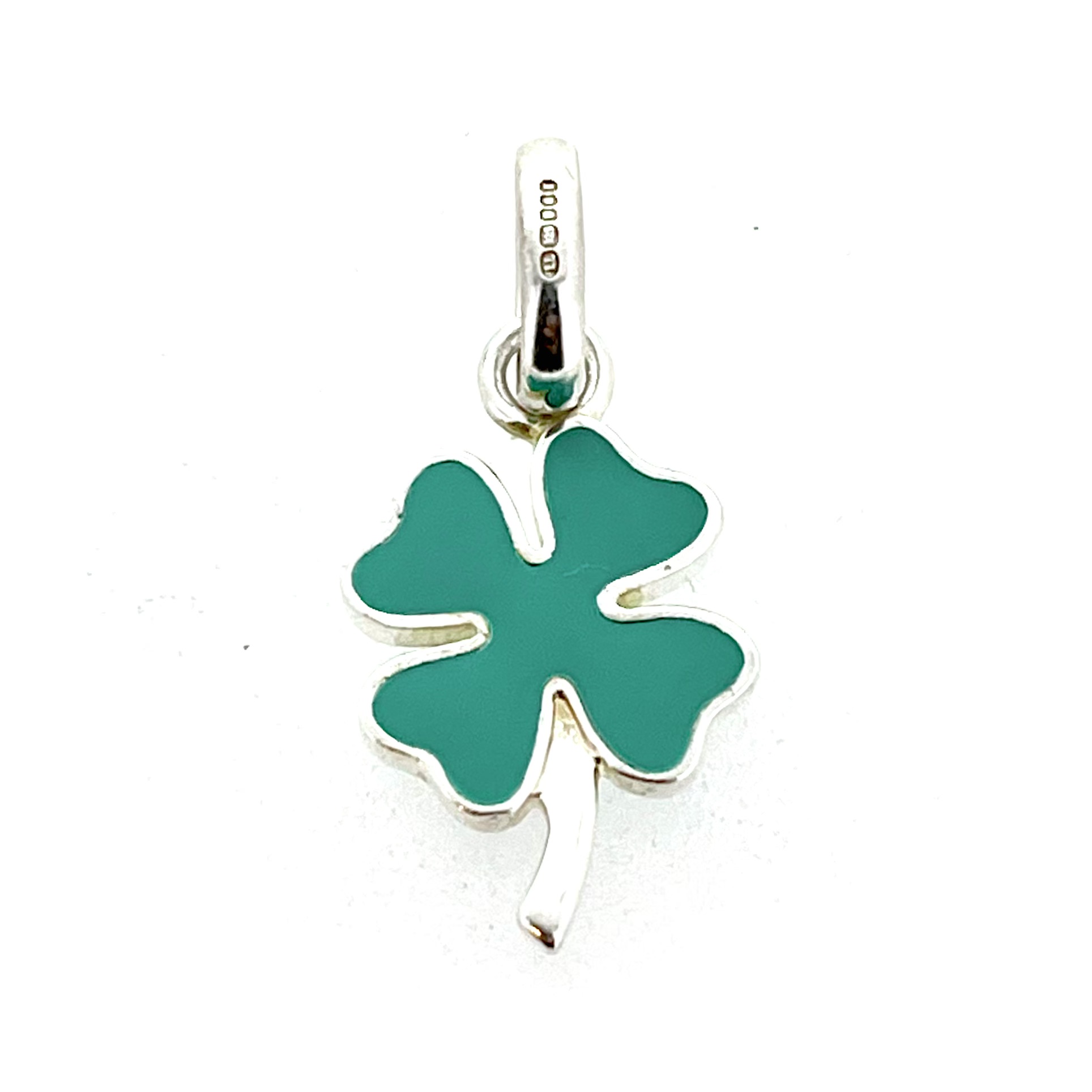 Opaque green enamel clover charm photographed on white background