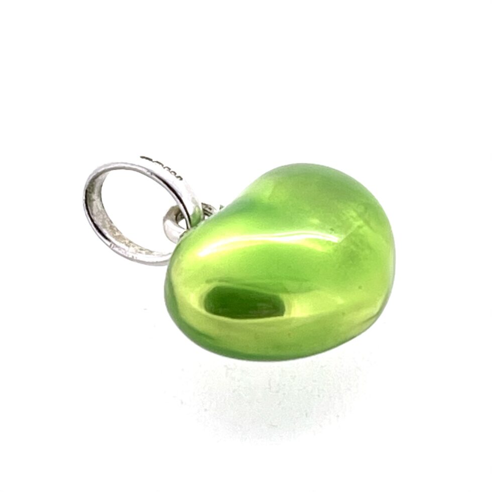 Macro of reflective enamel surface on heart charm