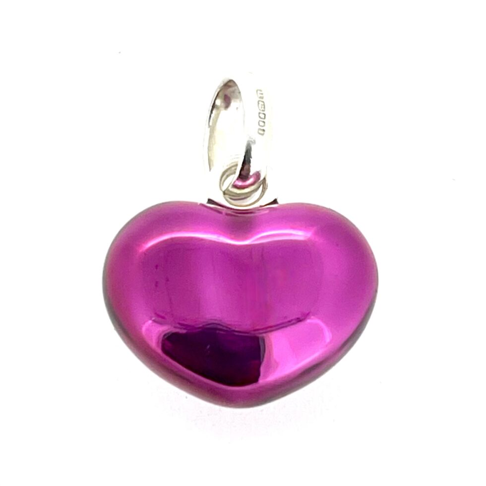 Bright purple enamel charm on white background