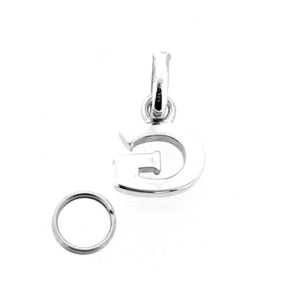 Letter G charm photographed on white background