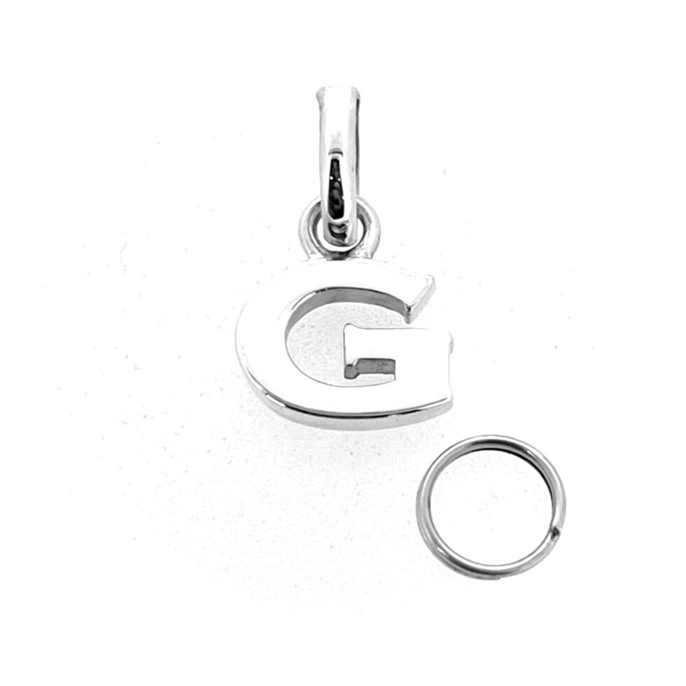 Close-up of polished block letter G charm