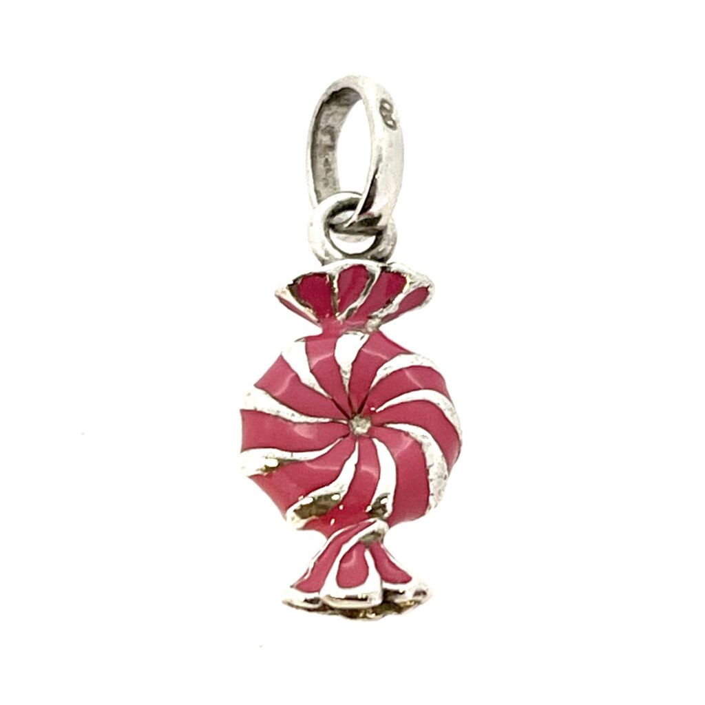 Pink enamel sweet charm photographed on white background
