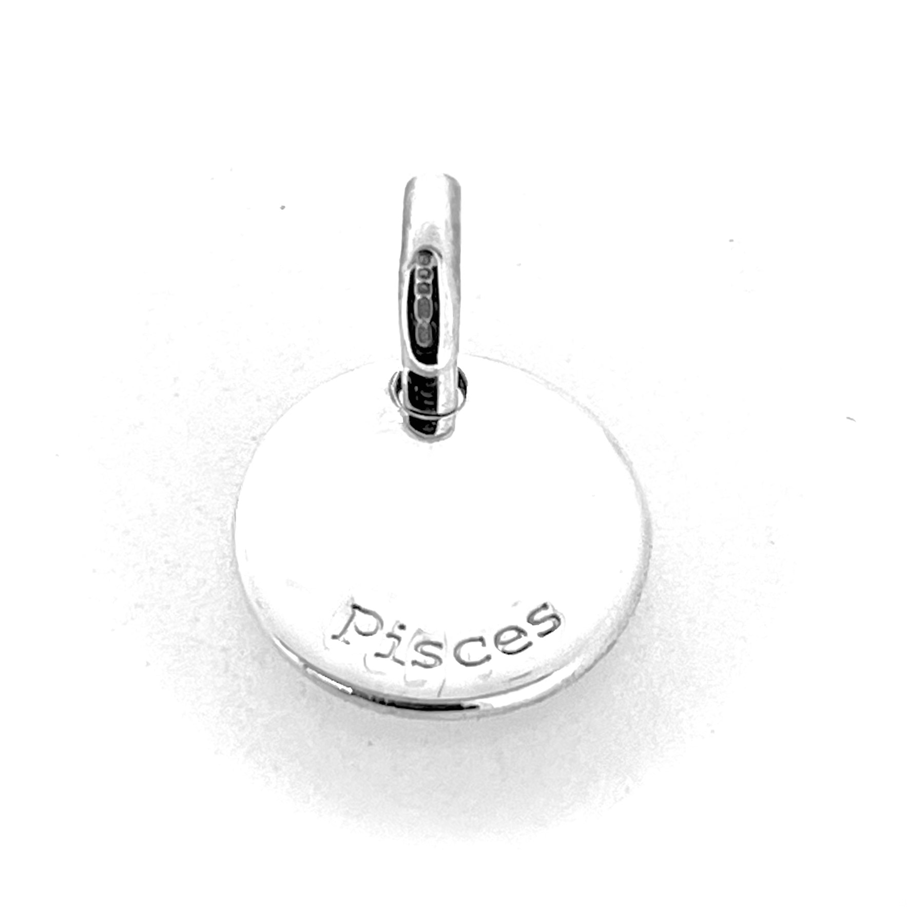 Reverse engraved Pisces text on silver disc