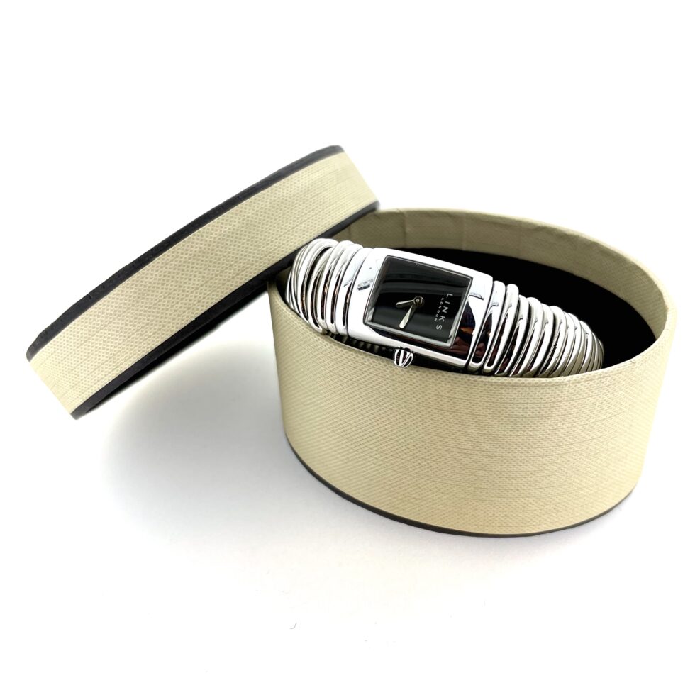 Watch displayed with vintage oval gift box.