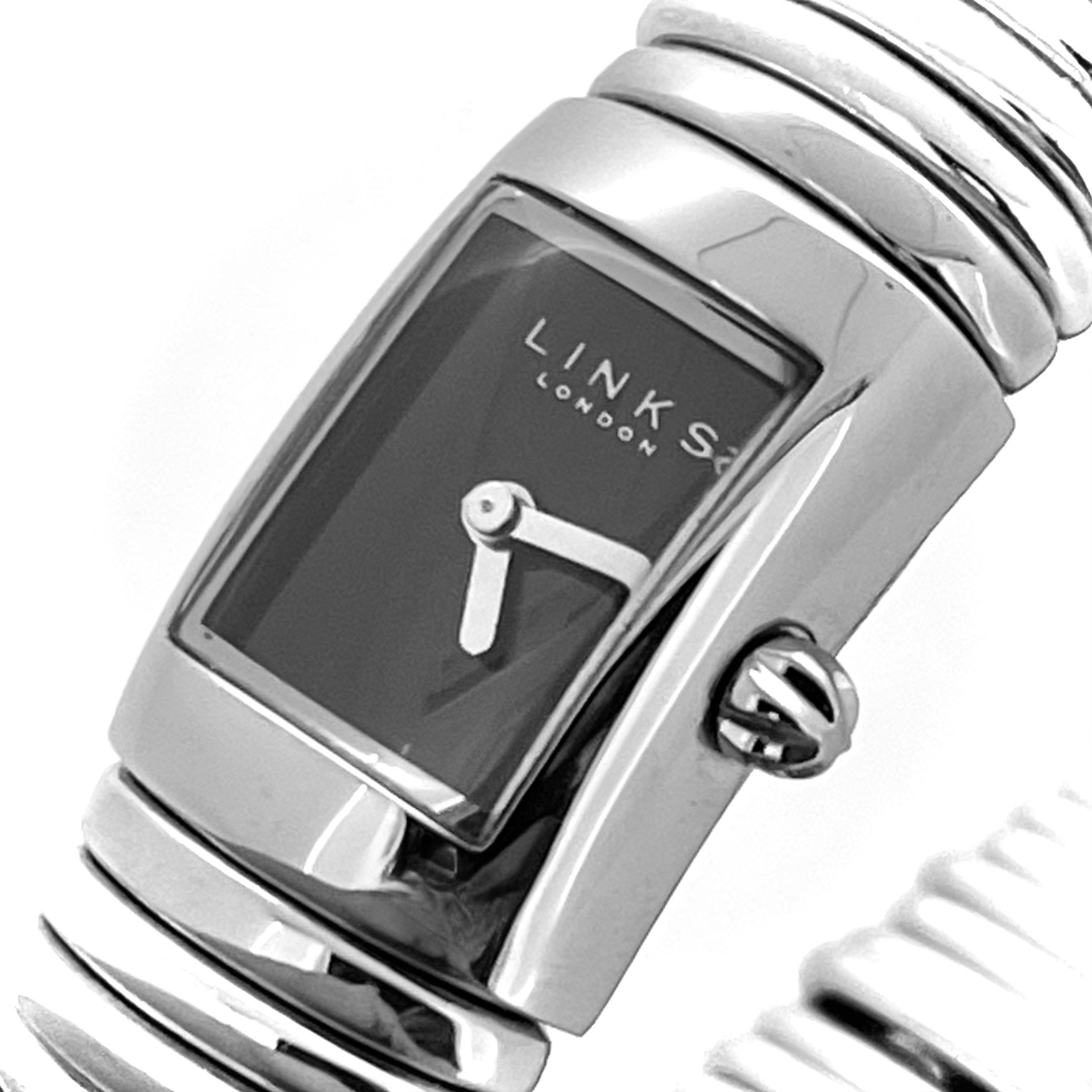 Close-up of black enamel-effect dial with silver baton hands.