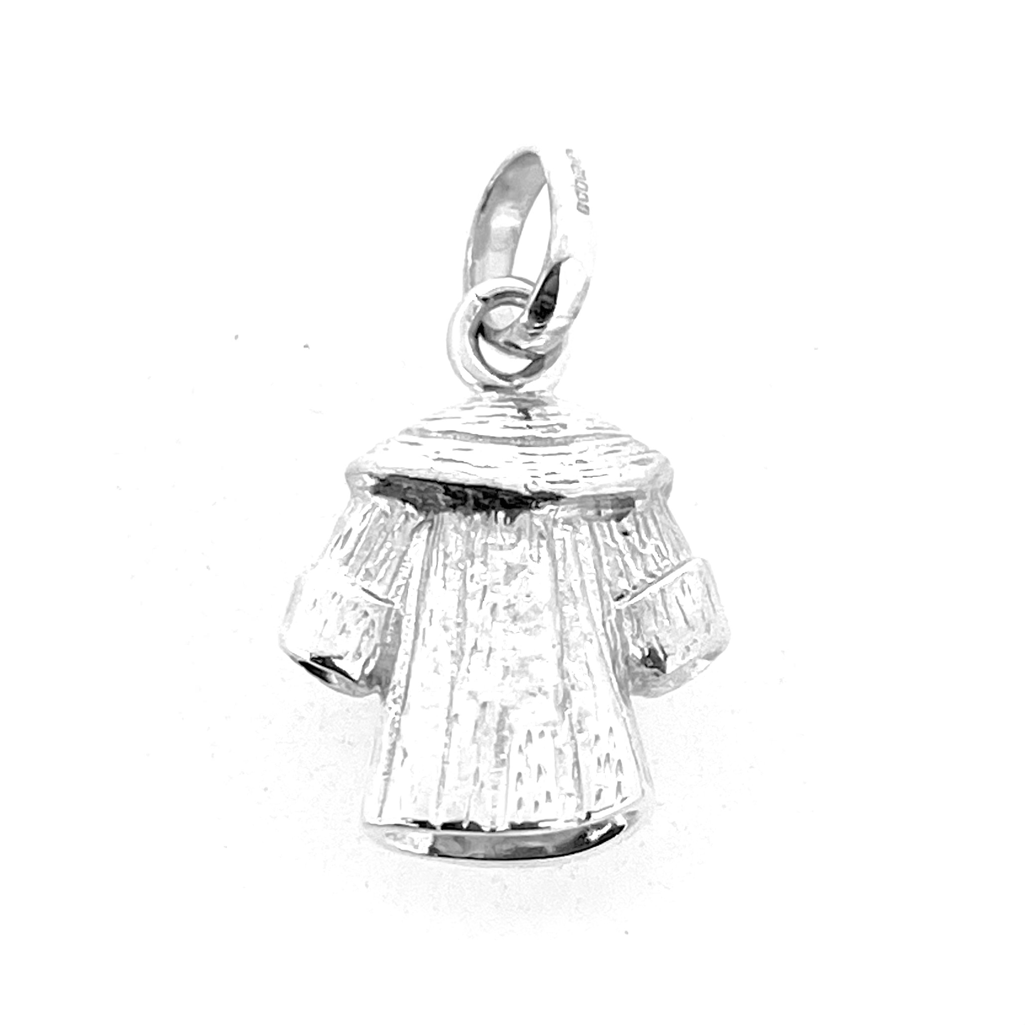 Miniature silver coat charm on white background
