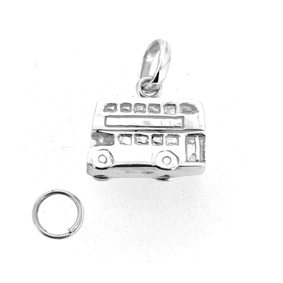 Polished silver surface reflecting London bus design details