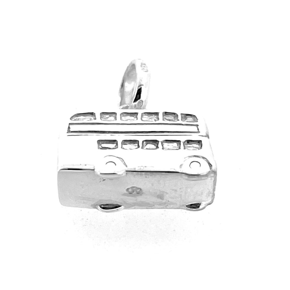 Detailed view of the charm’s wheel engravings and smooth silver finish