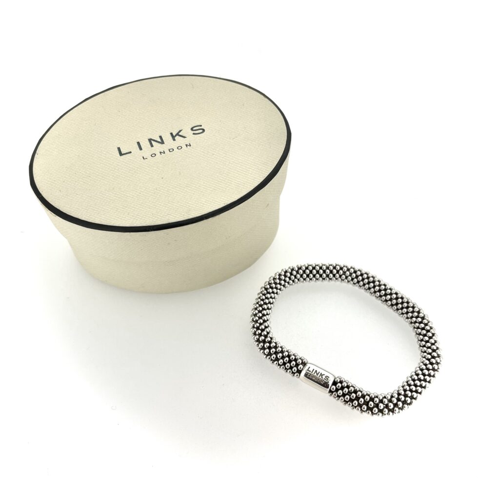 Vintage Links of London star bracelet on white background.