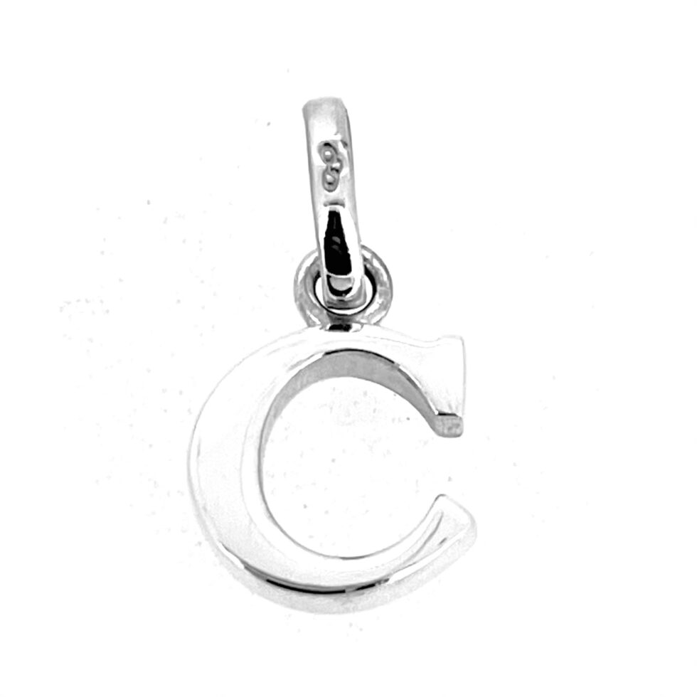 Close-up of rounded C initial charm