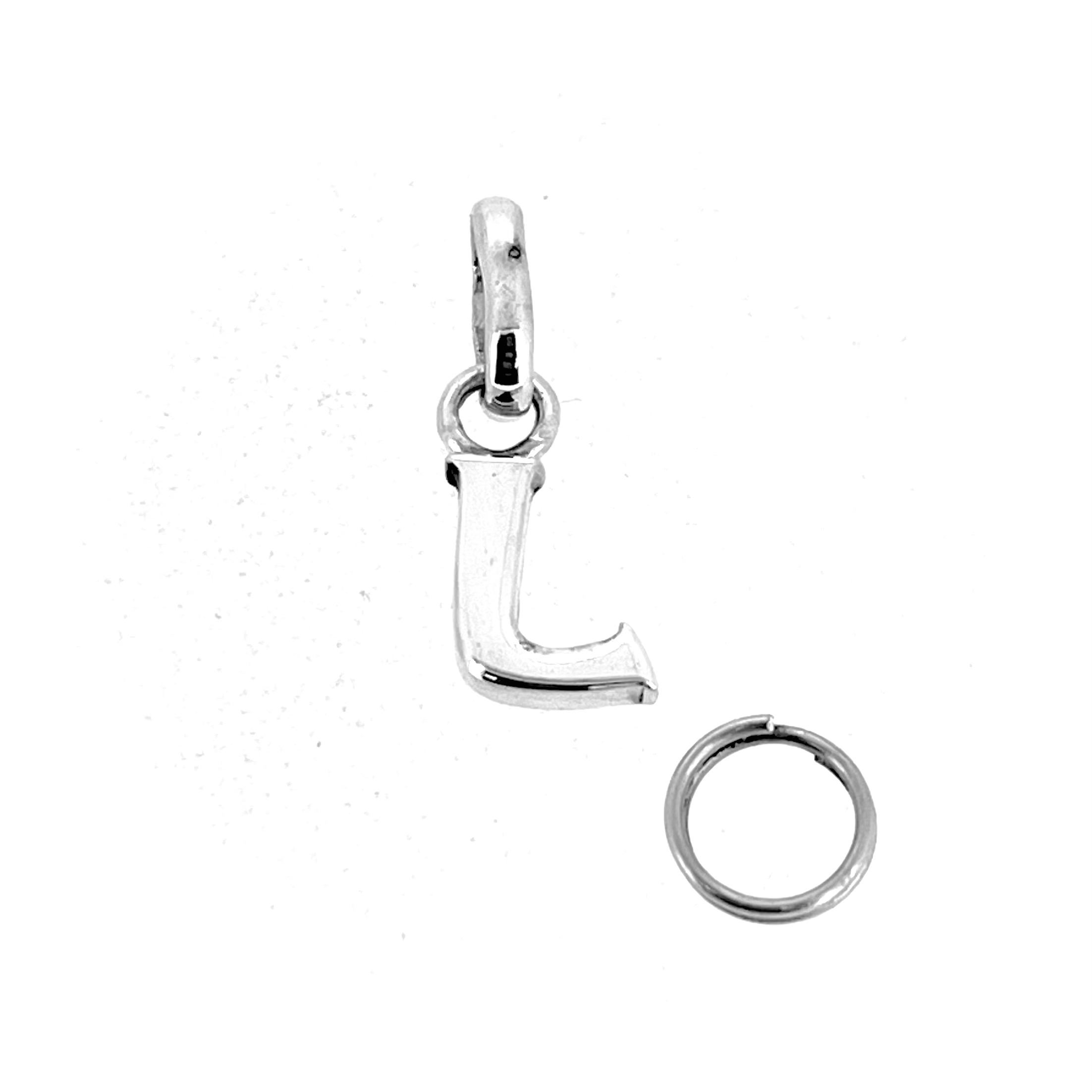 Sterling silver J charm photographed on white background