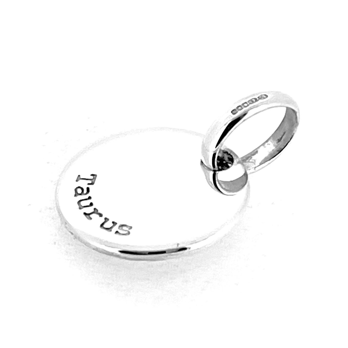 Taurus charm angled to show thickness and polish.