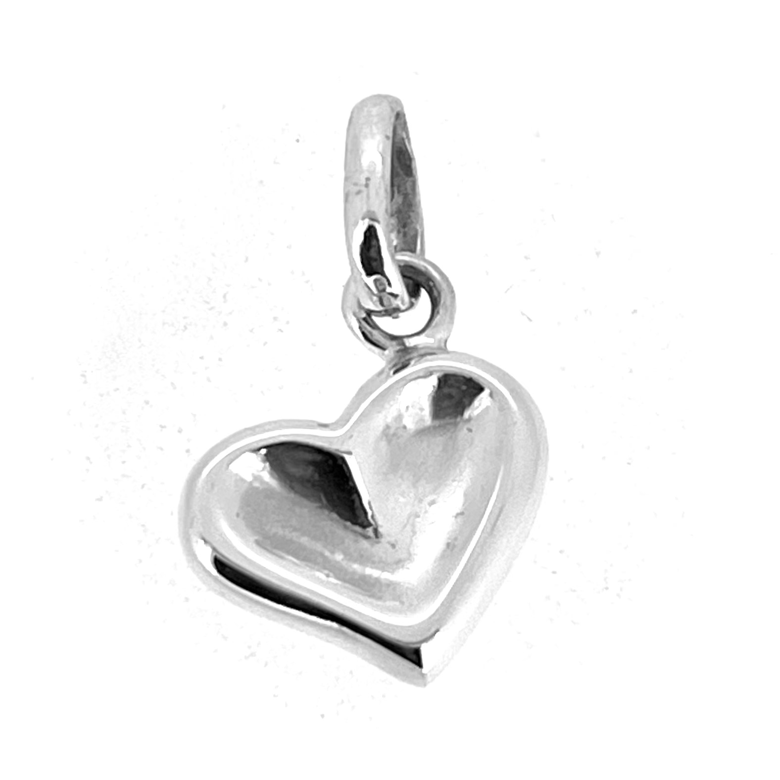 Close-up of Links of London thumbprint heart charm highlighting smooth silver surface