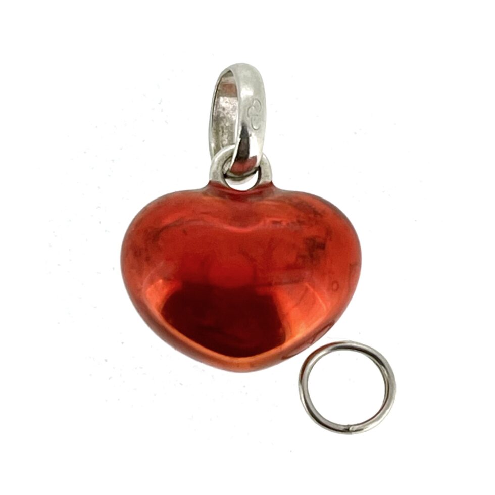 Vintage red enamel heart charm showing natural silver patina beneath