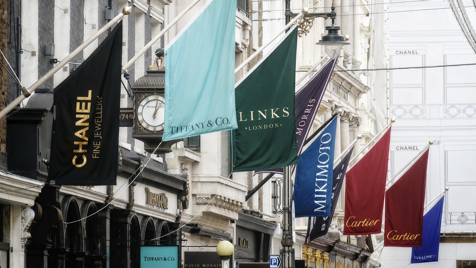 Flags of luxury jewellery houses displayed along Bond Street in Mayfair, London, including Links London among established retailers.