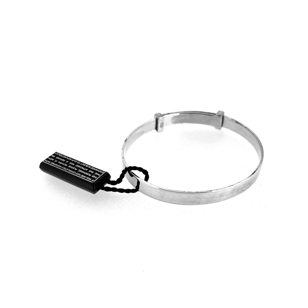 Expandable silver baby bangle with swing tag attached